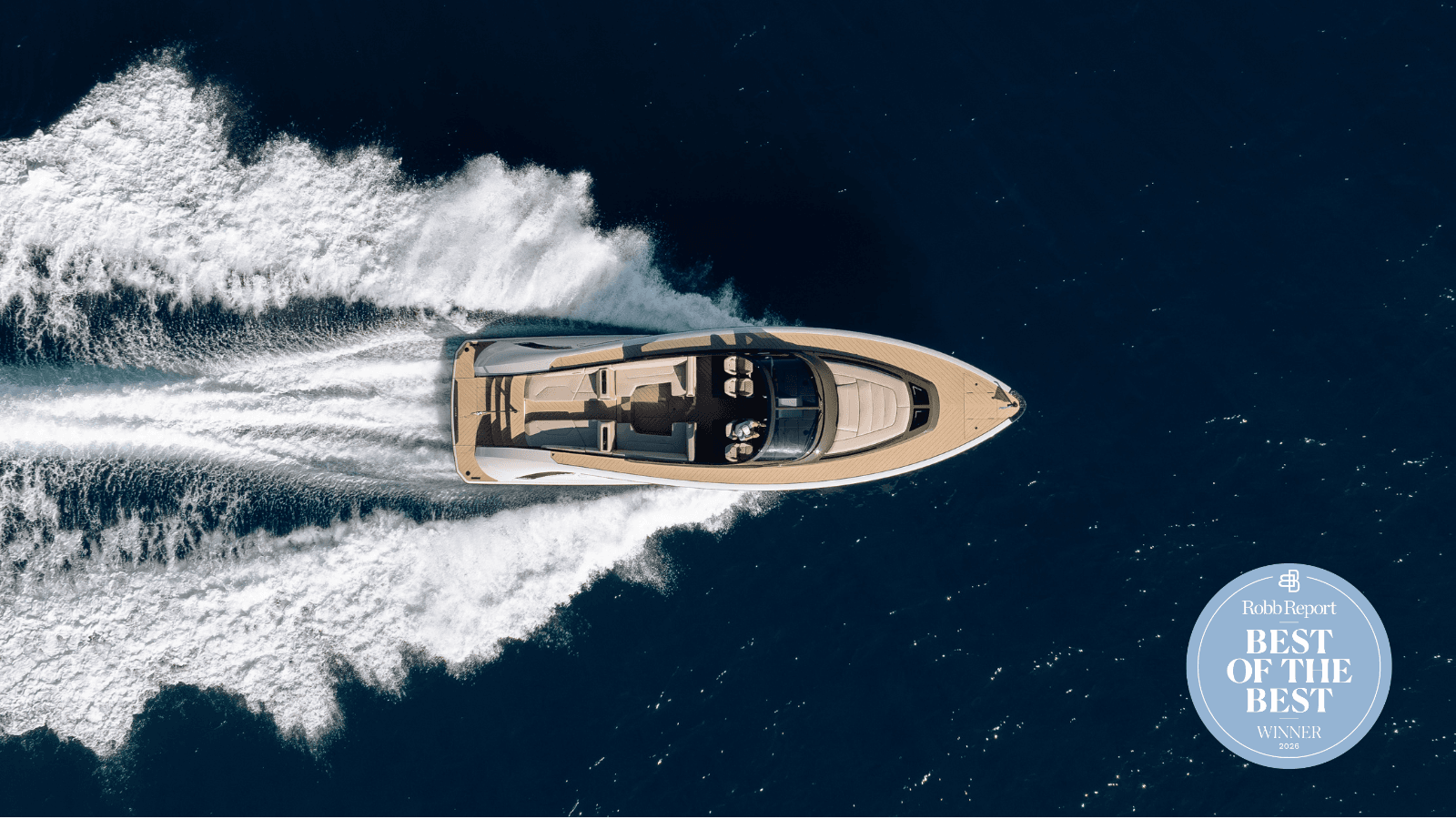 Aerial view of a luxury yacht speeding through deep blue water, creating white waves. "Best of the Best" winner badge displayed.